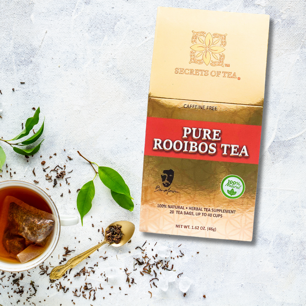 Box Of Secrets of Tea Rooibos tea alongside with a Tea brown liquid